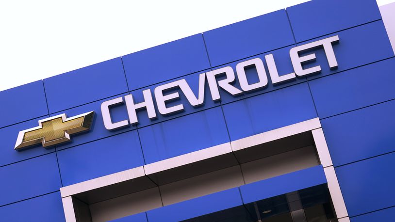 The Chevrolet logo is displayed on the facade of a dealership , Tuesday, Aug. 3, 2021, in Woburn, Mass. Despite a computer chip shortage that temporarily closed some of its factories, General Motors made a healthy $2.8 billion second-quarter net profit in the second quarter.  (AP Photo/Charles Krupa)