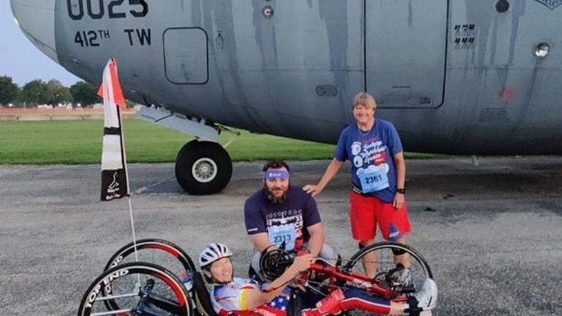 Holly Koester in her hand cycle and her twin sister Joy and their nephew Jared at the U.S, Air Force Marathon in 2022. Holly competed in the marathon —she has competed in all of them but one since the race began in 1997 – while Joy and Jared did the half marathon. Holly was a captain in the Army when she was paralyzed in an auto accident as she was preparing to deploy to Desert Storm.  Since her injury she has competed in 174 marathons and has already completed  the 50 states/ 50 marathons challenge once and is well on her way to  it again. She was inducted in the Ohio Veterans Hall of Fame in 2017, has been active in the Buckeye chapter of the Paralyzed Veterans of American for over 30 years and still works as a substitute teacher just outside of Cleveland. CONTRIBUTED
