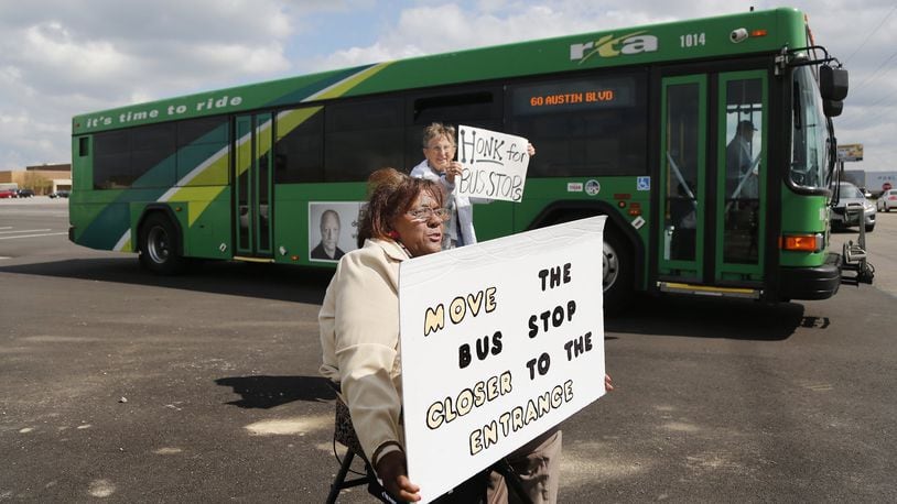 Marsha Johnson, front, and Paula Ewers, both with the group Leaders for Equality and Action in Dayton, protest the lack of a bus stop close to an entrance at the Dayton Mall in Miami Twp. CHRIS STEWART / STAFF