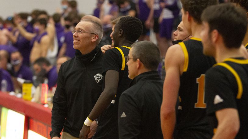 Centerville coach Brook Cupps smiles as he and his team watch the final seconds tick off the clock in Wednesday night's Division I region semifinal at Princeton High School. The Elks defeated Elder 52-43. Jeff Gilbert/CONTRIBUTED