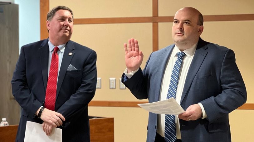 Russ Joseph is sworn in as deputy director of the Montgomery County Board of Elections on Wednesday, March 1, 2023, as elections director Jeff Rezabek looks on. AIMEE HANCOCK/STAFF