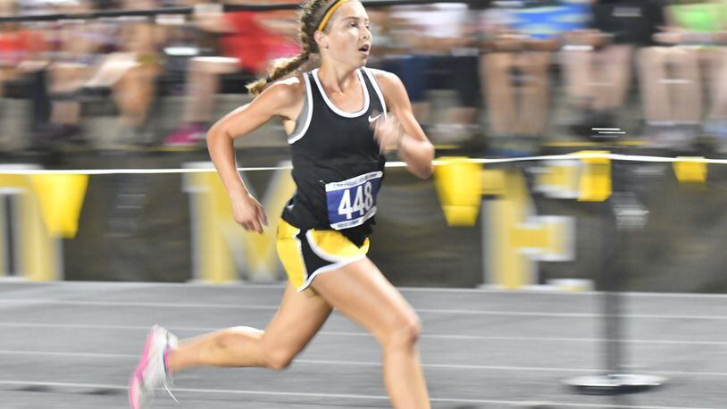 Centerville’s Emma Bucher runs toward the finish in the Saturday Night Lights meet in Centerville. Greg Billing/CONTRIBUTED