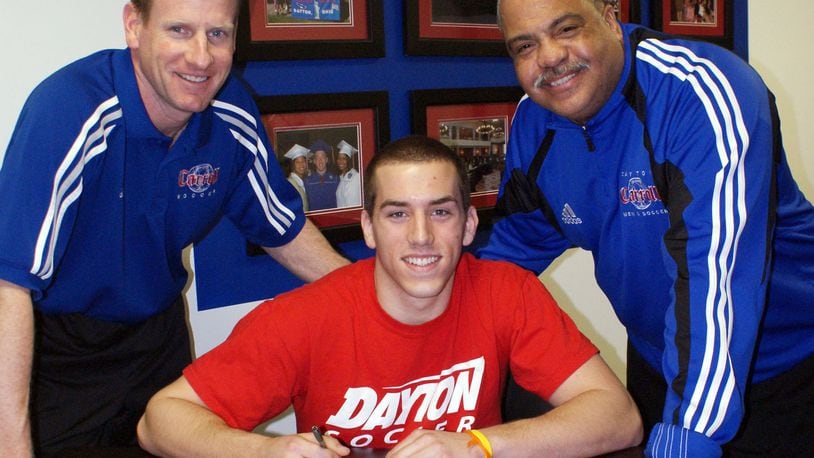 Carroll High School soccer All-American Jon Buschur signed a National Letter of Intent to continue his career at the University of Dayton in 2010. Joining Jon on Signing Day were Carroll coach Scott Molfenter (left) and assistant coach Daryl Jones. FILE PHOTO
