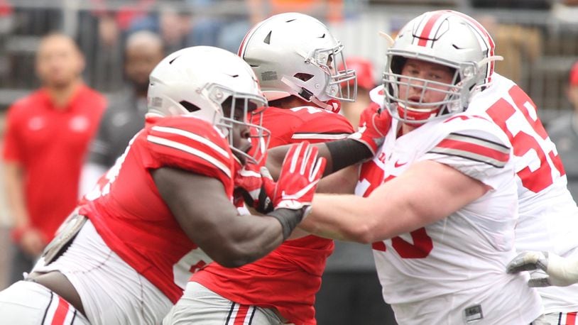 Ohio State’s Robert Landers, left, rushes against Brady Taylor during the spring game on Saturday, April 14, 2018, at Ohio Stadium in Columbus. Landers, a Wayne High School graduate, is one of several area players on the Buckeyes’ roster this season. David Jablonski/Staff