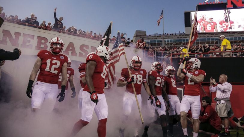 Nebraska players linebacker Luke Gifford (12), defensive back Eric Lee Jr. (6), fullback Harrison Jordan (38), and others, walk out of the tunnel before a game against Wisconsin in Lincoln, Neb., Saturday, Oct. 7, 2017. (AP Photo/Nati Harnik)