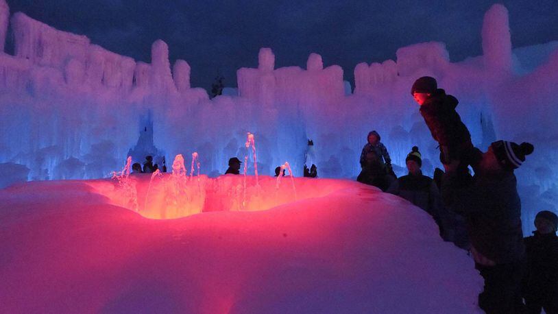 A fountain is one of the most popular features for visitors to the Dillon Ice Castles. Tate Shellenberger gets a lift from his dad, Ryan Shellenberger, to look into the lit fountain on Friday, January 5, 2018. Ice Castles is a Utah-based entertainment company that specializes in large-scale events handcrafted from ice. (Jerilee Bennett/Colorado Springs Gazette/TNS)