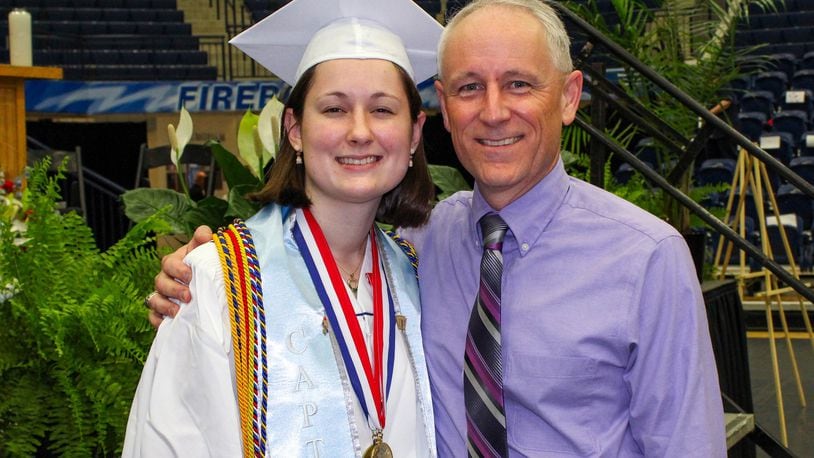 Carroll High School co-valedictorian Maria Schlegel celebrates her graduation with her father, Dave Schlegel, on May 18, 2018 at Trent Arena in Kettering. Maria followed in her father’s footsteps, as Dave was Carroll’s valedictorian 30 years earlier. CONTRIBUTED