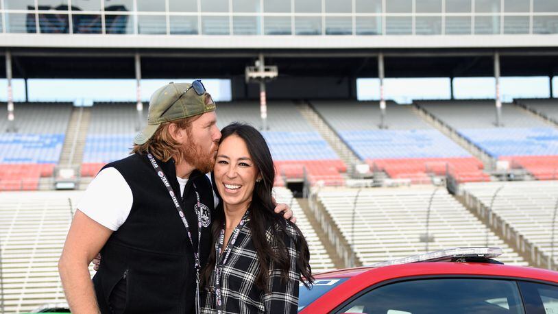 FORT WORTH, TX - NOVEMBER 05:  'Fixer Upper' stars Chip and Joanna Gaines pose with the Monster Energy NASCAR Cup Series AAA Texas 500 pace car at Texas Motor Speedway on November 5, 2017 in Fort Worth, Texas.  (Photo by Jared C. Tilton/Getty Images)