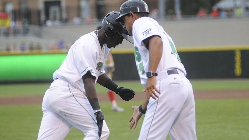 Dragons manager Luis Bolivar (right) congratulates Hector Vargas after a solo home run last season. MARC PENDLETON / STAFF
