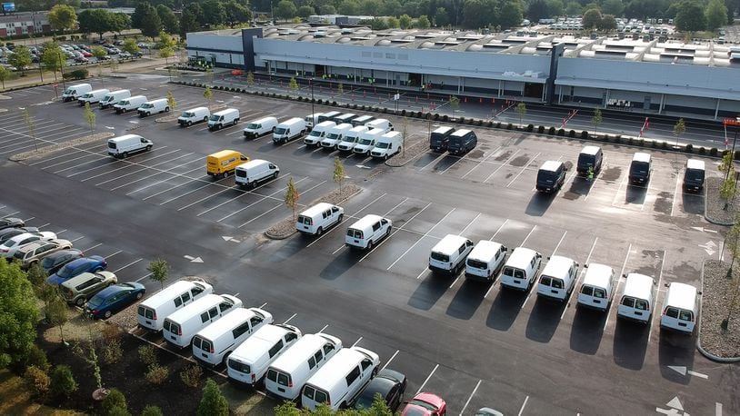 Amazon is ramping up its operation in the Kettering Business Park, seen in this recent photo. Delivery vans have been filling the parking lots of the distribution center for about three weeks. TY GREENLEES / STAFF