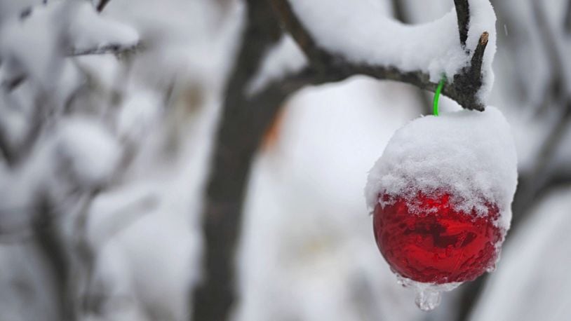 Snow covered much of the area, including this tree and Christmas ornament near Fairborn, after the Miami Valley's first snowfall of 2020 on Nov. 30. MARSHALL GORBY/STAFF