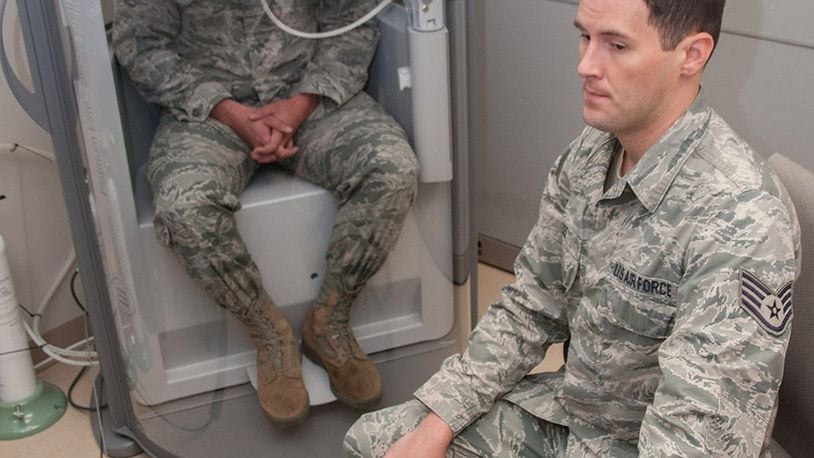 Staff Sgt. Jonathon Lee, pulmonary technician with the Aeromedical Consultation Service Internal Medicine Branch, conducts a demonstration of a pulmonary function test for forced vital capacity as Staff Sgt. Sean O’Neill sits in a pressurized cabin awaiting the command to exhale. The branch reviews around 700 requests for waiver recommendation cases annually concerning pilots, navigators and other aircrew, with 90 percent of them receiving waiver recommendations. (U.S. Air Force photo/John Harrington)
