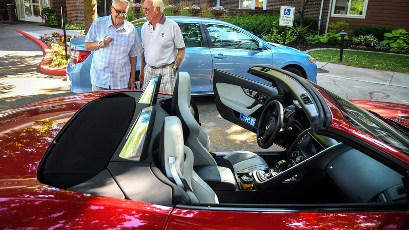 Ron Schoenberger, right, socializes with his friend John Anderson, left, as the pair look over Schoenberger s recently purchased 2015 Jaguar F-Type sports car on Thursday, July 26, 2018, at Touchmark on South Hill in Spokane, Wash. (Dan Pelle/The Spokesman-Review/TNS)