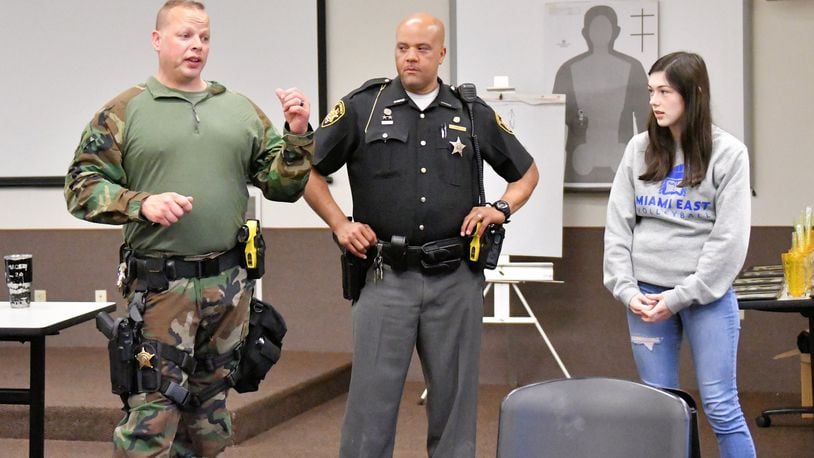 Miami County Sheriff’s Lt. Todd Tennant, left, and Deputy Warren Edmondson, center, talk with police academy students about standoffs with police and hostage negotiations. CONTRIBUTED
