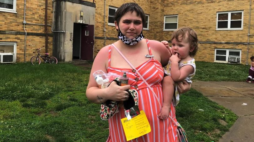 Michelle Libecap, with her 14-month-old daughter, outside of the apartments at 1119 Linda Vista Ave.