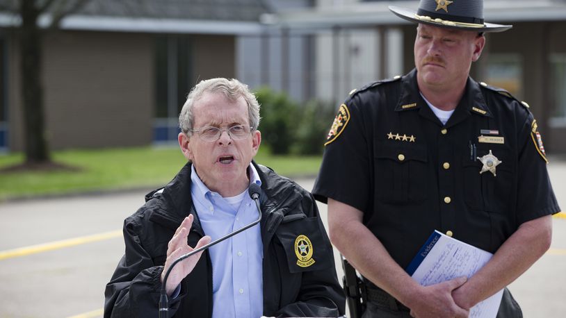 FILE - In this April 27, 2016, file photo, Ohio Attorney General Mike DeWine, left, and Pike County Sheriff Charles Reader, right, discuss the slayings of eight members of the Rhoden family found shot April 22, 2016, at four properties near Piketon, Ohio, during a news conference in Waverly, Ohio. The office of DeWine released redacted autopsy reports Friday, Sept. 23 in the unsolved slayings of the seven adults and a teenage boy, confirming all but one victim was shot multiple times in the head. (AP Photo/John Minchillo, File)