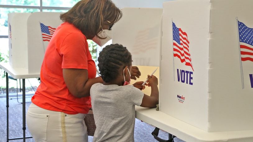 A woman gets some help filling out her ballot Tuesday, August 2, 2022 at the election poll in the Springfield Township Government Center. BILL LACKEY/STAFF