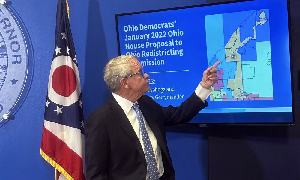 Ohio Gov. Mike DeWine points to a map during a press conference in Columbus, Ohio, Wednesday, July 31, 2024, where he opposed a fall ballot measure aimed at remaking the state's troubled political mapmaking system. If it passes, DeWine said he will work with state lawmakers next year to advance a competing amendment based on the Iowa model. (AP Photo/Julie Carr Smyth)