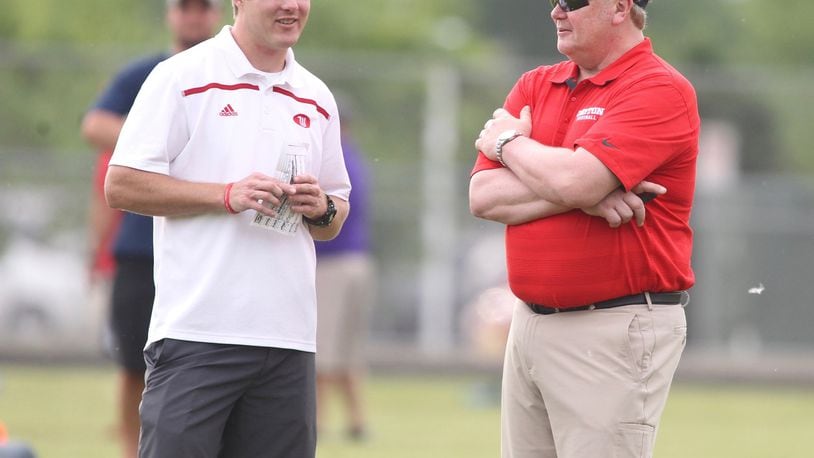 Wittenberg offensive coordinator Kevin Hoyng, left, talks with his former coach, Dayton’s Rick Chamberlin at Michigan’s satellite camp at Springfield High School on June 1, 2016. David Jablonski/Staff