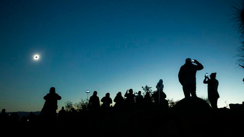 People view a total solar eclipse from La Higuera, Chile, Tuesday, July 2, 2019. Tens of thousands of tourists and locals gaped skyward Tuesday as a rare total eclipse of the sun began to darken the heavens over northern Chile.