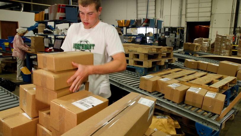 Logan Murphy, a shipping employee for Lastar, packages boxes to be sent throughout North America in this 2010 file photo. Lastar is a manufacturer of low voltage cable and connectivity products. FILE.