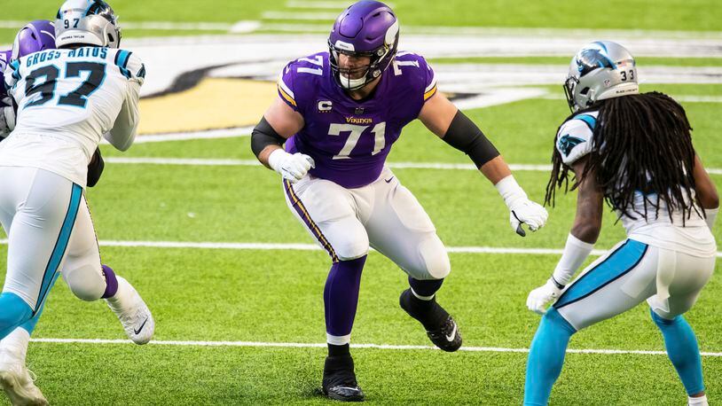 File-This Nov. 29, 2020, file photo shows Minnesota Vikings offensive tackle Riley Reiff (71) in action in the third quarter of an NFL football game against the Carolina Panthers in Minneapolis. Cincinnati bolstered its offensive line, which was a glaring weakness in a 4-11-1 2020 season, with the signing of ex-Vikings Reiff as the team seeks better protection for quarterback Joe Burrow.  (AP Photo/David Berding, File)