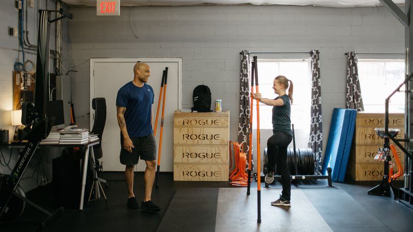 Jason Harrison, left, goes through a workout at Present Tense Fitness. Sarah Rose Photography