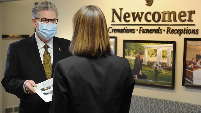Jed J. Dunnichay, Funeral Director for Newcomer, talks with a potential client Friday, Dec. 18, 2020 at the Newcomer Cremations, Funerals and Receptions location in Centerville. MARSHALL GORBY\STAFF