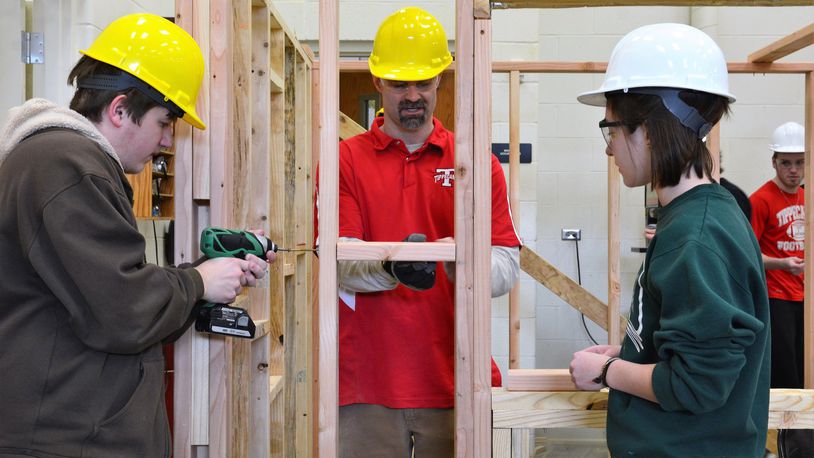 Instructor Jim Kitchen (center) works with Tippecanoe High School students working to build a tiny house. CONTRIBUTED