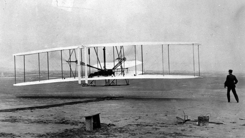 Orville Wright is at the controls of the "Wright Flyer" as his brother Wilbur Wright looks on during the plane's first flight at Kitty Hawk, N.C., in this Dec. 17, 1903.