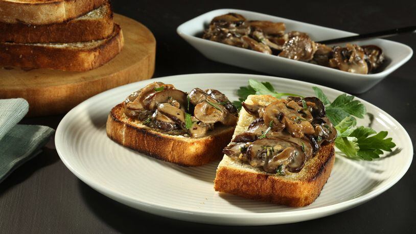A mix of mushrooms is sauteed with shallots then flavored with sherry and cream to make a rich topping for toast. (Joan Moravek/food styling) (Chris Walker/Chicago Tribune/TNS)