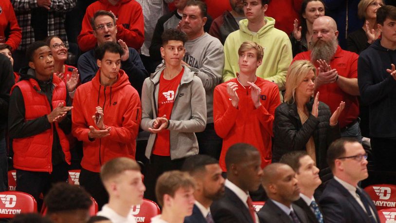 Dayton recruits Koby Brea, center, and Lukas Frazier, right center, watch from behind the bench during a game against Indiana State on Saturday, Nov. 9, 2019, at UD Arena.