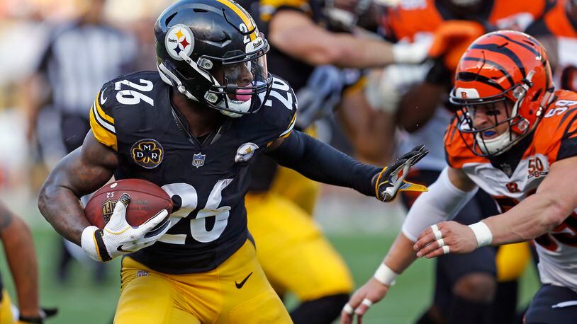 Pittsburgh Steelers running back Le’Veon Bell (26) gets past Cincinnati Bengals defensive end Carl Lawson (58) during the first half of an NFL football game in Pittsburgh, Sunday, Oct. 22, 2017. (AP Photo/Keith Srakocic)