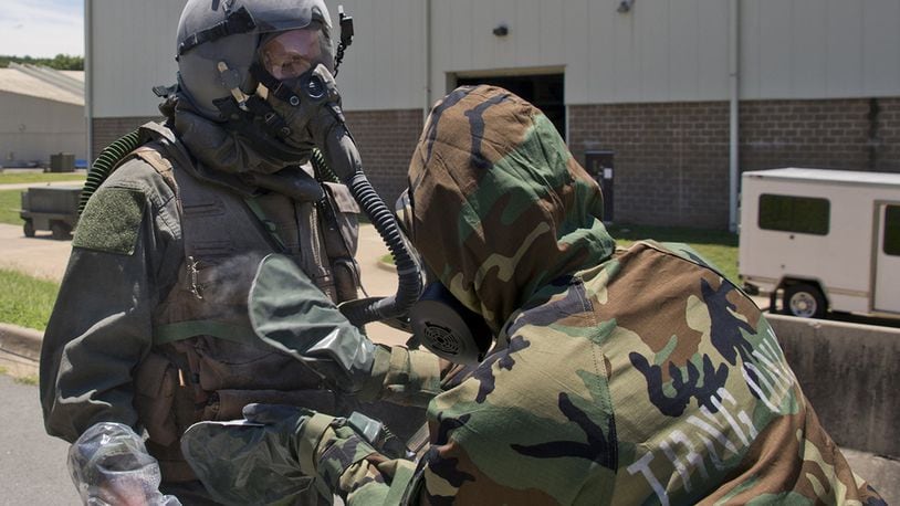 Air Force Reserve Staff Sgt. Casey Godwin, aircrew flight equipment specialist, 327th Operations Support Squadron, pats down Staff Sgt. Michael Hopson, loadmaster, 327th Airlift Squadron, with activated charcoal from an M295 Individual Decontamination Kit during a training scenario. The Air Force Civil Engineer’s Readiness Lab recently determined more than 75,000 expired M295 decontamination kits used in chemical defense ensembles are still effective and can be used, saving the Air Force more than $2.3 million over a 4-year period. (U.S. Air Force photo/Master Sgt. Jeff Walston)