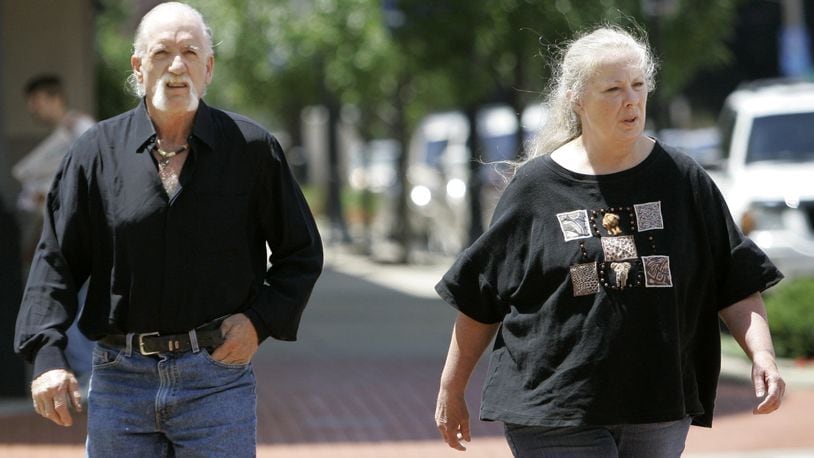 This Wednesday, July 11, 2007, file photo shows Michael and Sharen Gravelle walking through downtown Norwalk, Ohio. Attorneys for 11 adopted and foster children forced to sleep in cages by their adoptive parents in northern Ohio have reached a $2 million settlement. Their adoptive parents, the Gravelles, spent two years in prison for abusing some of the children.