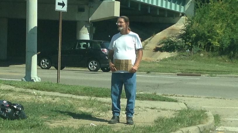 Since Dayton changed its laws on panhandling in August, the city’s intersections have seen an explosion of people begging for money. BRIAN KOLLARS / STAFF