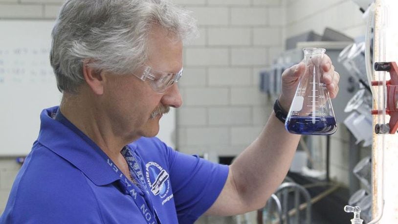 Tim Truman, a city of Dayton Department of Water research and control specialist, demonstrates how water is sampled for mineral content at the city’s Ottawa Water Treatment Plant. CHRIS STEWART / STAFF