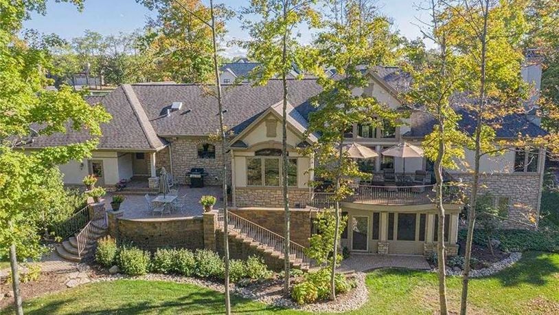 The back of the home allows for private outdoor enjoyment with a paver-brick patio that has two apron staircases that lead down to the back yard and a wood-composite deck accessible from the main bedroom.