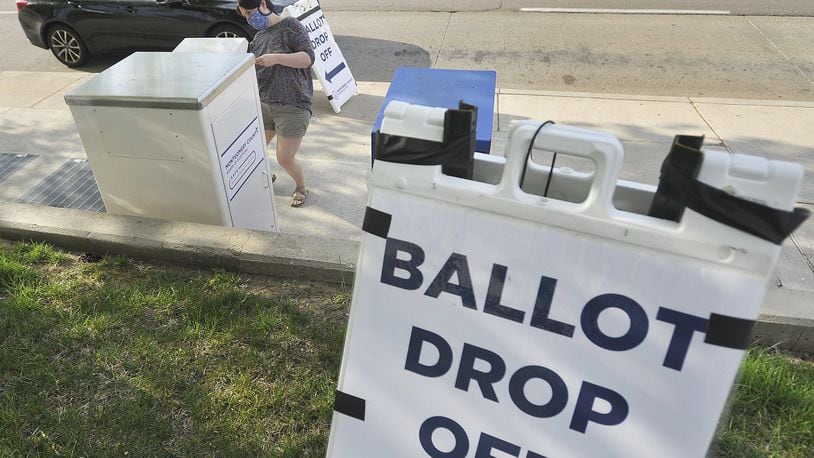 Shelli DeFranco uses the dropbox outside the Montgomery County Board of Elections located on Third Street to drop-off her ballot Tuesday. MARSHALL GORBYSTAFF
