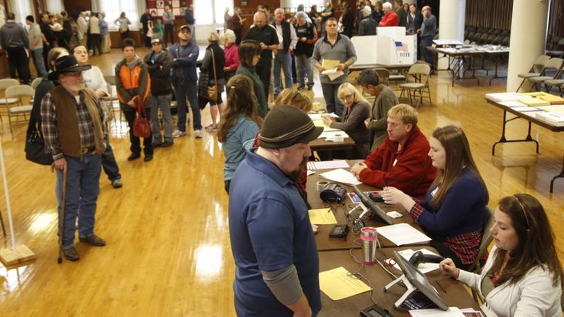 Voters at Community Golf Course in Kettering were met with a long line inside the polling place. Most voters reported waiting at least one hour to cast their ballots around noon. (Ty Greenlees/Staff)
