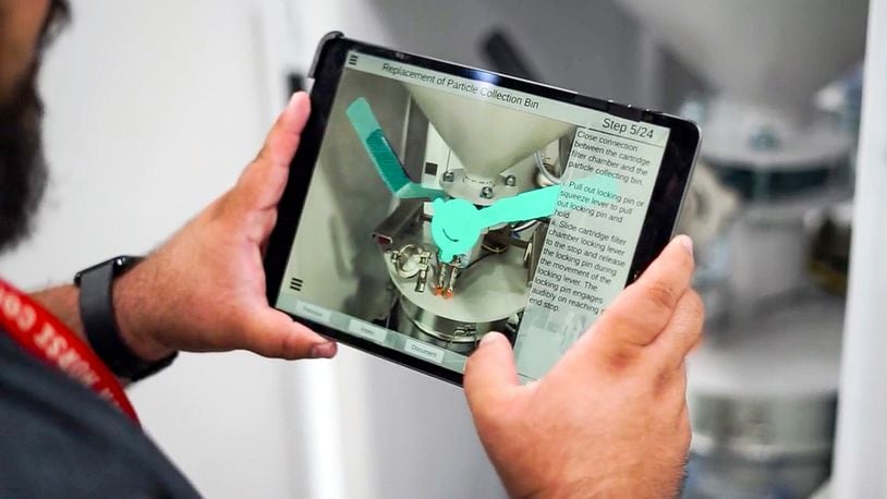 University of Dayton Research Institute computer program Technician Noah Calderon shows how augmented reality can be used to assist in systems maintenance. Contributed