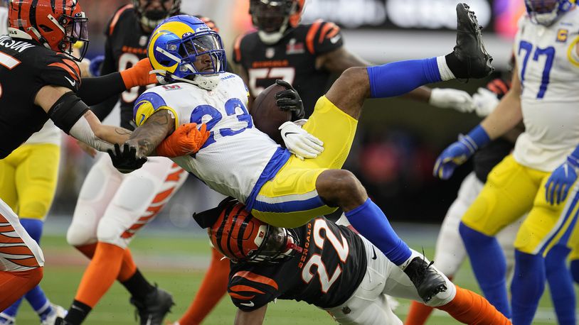 Los Angeles Rams running back Cam Akers (23) is tackled by Cincinnati Bengals cornerback Chidobe Awuzie (22) during the first half of the NFL Super Bowl 56 football game Sunday, Feb. 13, 2022, in Inglewood, Calif. (AP Photo/Marcio Jose Sanchez)