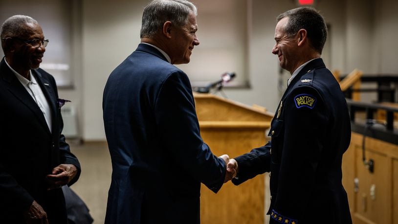 Retired Dayton police chief Richard Biehl attends the swearing-in of interim Dayton director and chief of police Matt Carper Friday July 30, 2021, at Dayton City Hall. City Commissioner, Jeffrey Mims is on the left.  JIM NOELKER/STAFF