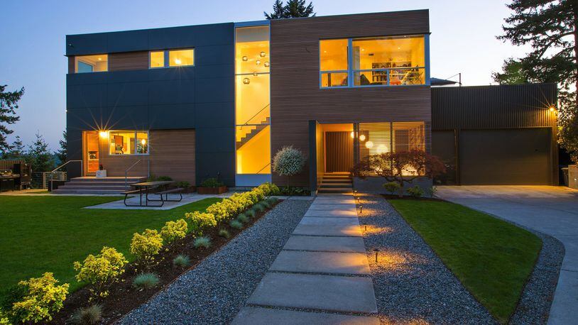 Because the residence sits directly on top of one of Bellevue s tallest hills, the approach needed to be dramatic, says architect Andrew van Leeuwen of BUILD. A ground-to-sky window is lit with six Graypants recycled cardboard lights that lead visitors to the house, where nine glowing spheres illuminate a covered, screened entry area. CLS Landscape Services did the landscaping. (Mike Siegel/The Seattle Times/TNS)