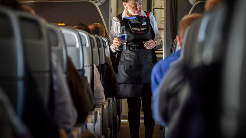 Flight attendant Bette Nash checks on her American Airlines passengers on an American Airlines flight. Washington Post photo by Bill O’Leary.