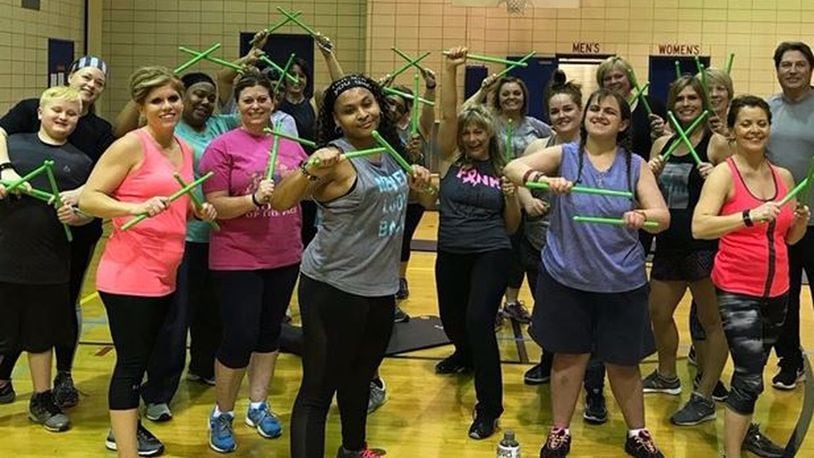 Brandi Collins with participants in a Pound fitness class. CONTRIBUTED