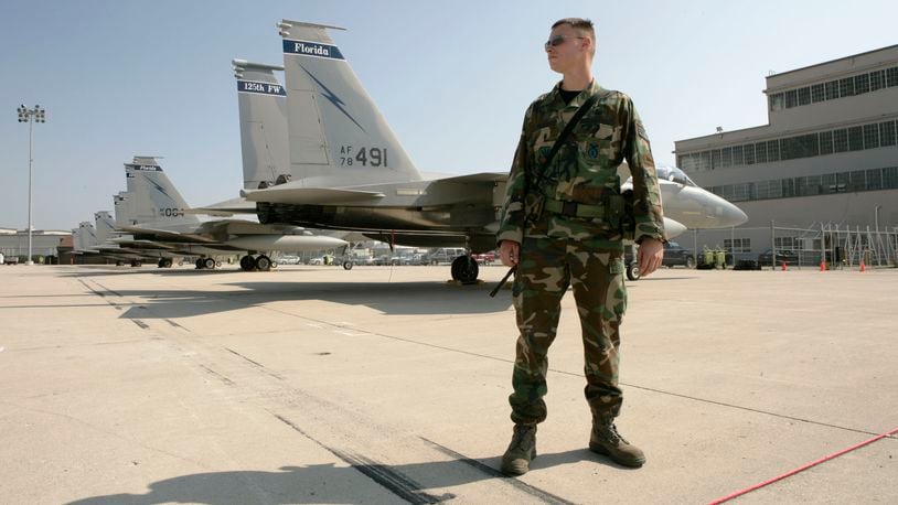 SSgt. Glenn Fritch with the 125th Security Forces Squadron from the Florida Air National Guard watches over the 13 F-15 Eagles flown to Wright-Patterson Air Force Base until Tropical Storm Hanna passes by Florida. Base Spokesman Derek Kaufman exects more airplanes including F-15E Strike Eagles form Seymour Johnson AFB in North Carolina and C-17 Globemasters from Charleston AFB in South Carolina on Friday. Staff photo by Ty Greenlees.