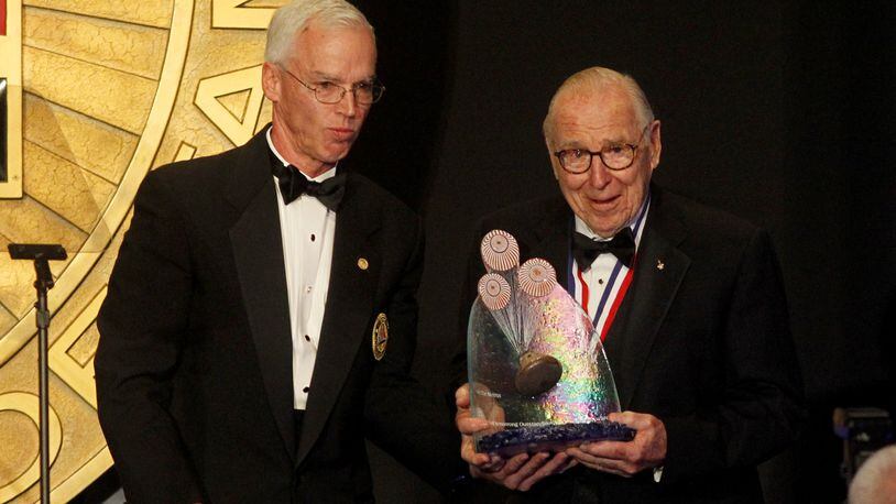 Apollo 13 astronaut James A. Lovell (right) received the first Neil Armstrong Outstanding Achievement Award at the National Aviation Hall of Fame ceremony held in October 2015 at the National Museum of the United States Air Force at Wright-Patterson Air Force Base. At left is William Harris Jr., the National Aviation Hall of Fame chairman of the board. LISA POWELL / STAFF