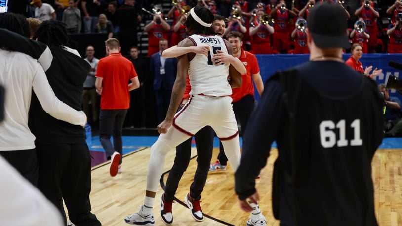 Dayton's DaRon Holmes II celebrates after a victory against Nevada in the first round of the NCAA tournament on Thursday, March 21, 2024, at the Delta Center in Salt Lake City, Utah. David Jablonski/Staff