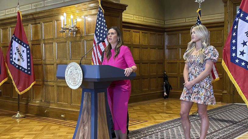 Arkansas Gov. Sarah Huckabee Sanders speaks at a news conference next to former Kentucky swimmer Riley Gaines at the state Capitol in Little Rock, Ark., Thursday, May 2, 2024. Sanders spoke before signing an executive order stating that Arkansas won't comply with new federal regulations intended to protect the rights of transgender students. (AP Photo/Andrew DeMillo)